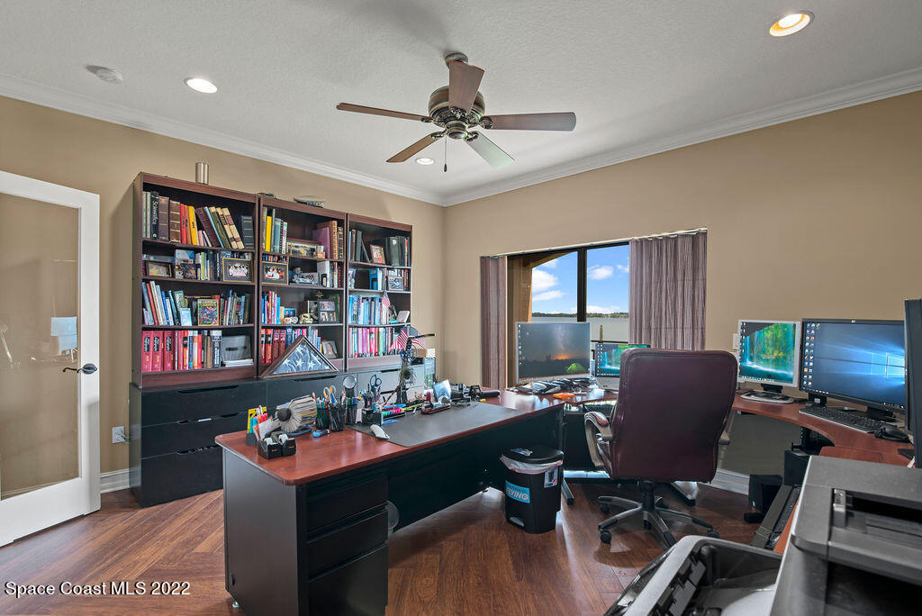 1 Pisces Lane Rockledge, FL 32955 - Photo 42 of 61 a work room with furniture a bookshelf and a window