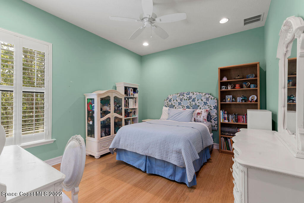 1 Pisces Lane Rockledge, FL 32955 - Photo 49 of 61 a bedroom with a bed and a table in it