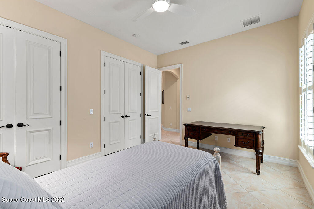1 Pisces Lane Rockledge, FL 32955 - Photo 53 of 61 a bedroom with a bed and a chandelier