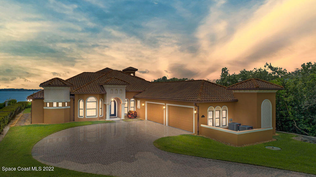 1 Pisces Lane Rockledge, FL 32955 - Photo 8 of 61 a view of a big house with a big yard and large trees