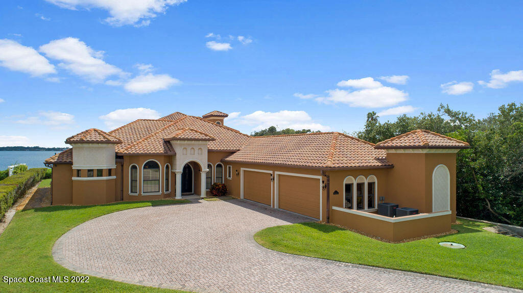 1 Pisces Lane Rockledge, FL 32955 - Photo 9 of 61 a front view of a house with a yard and garage
