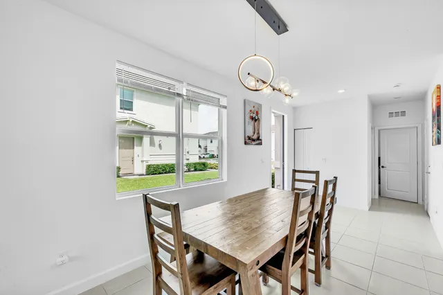 a view of a dining room with furniture and window