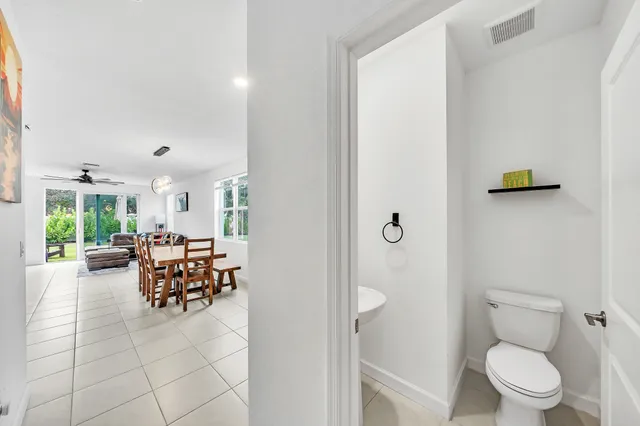 a dining room with furniture and a toilet