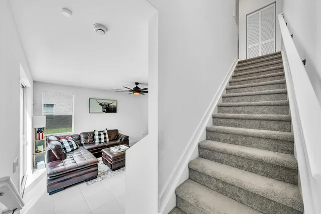 a living room with furniture and a stair