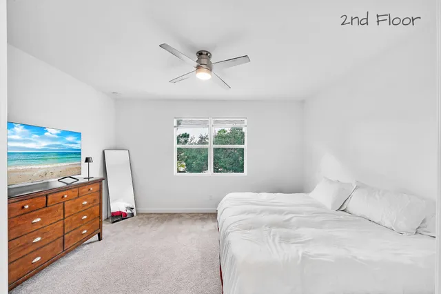 a bedroom with a bed dresser and a window