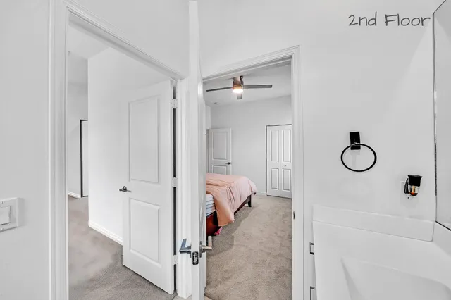 a view of a room that has a bed and a chandelier