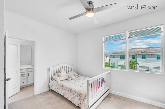 a bedroom with a bed and a large window