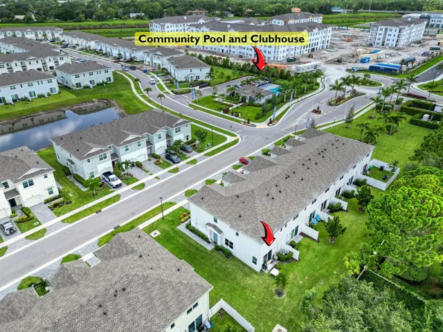 an aerial view of a tennis ground and a swimming pool