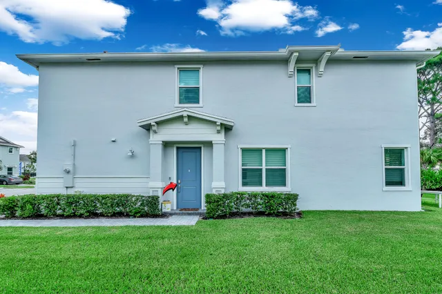 a front view of a house with plants