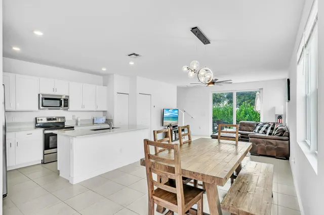a large kitchen with kitchen island a large counter top space appliances and a center island