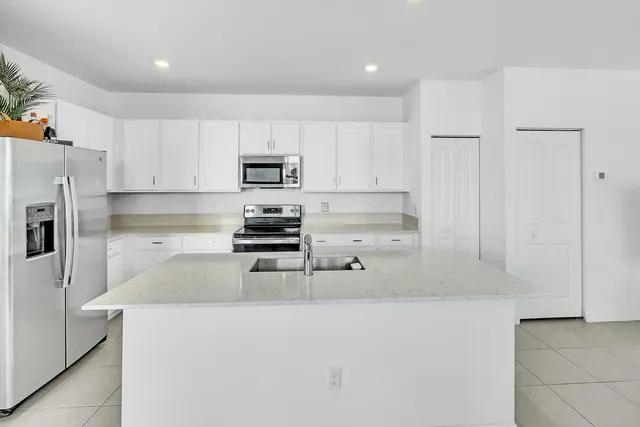 a kitchen with stainless steel appliances a refrigerator a stove a microwave and cabinets