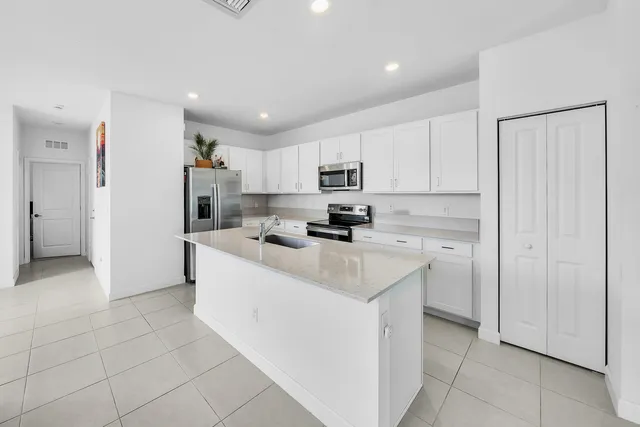 a kitchen with stainless steel appliances a refrigerator sink and cabinets