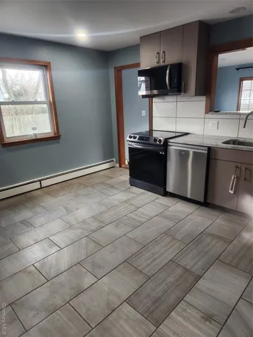 a kitchen with stainless steel appliances a sink and a microwave