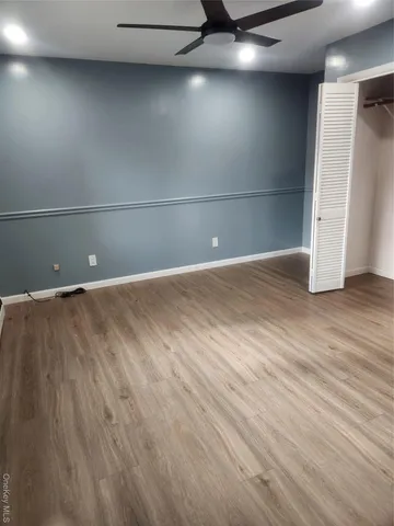a view of a room with wooden floor