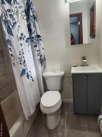a white toilet sitting next to a bathroom sink