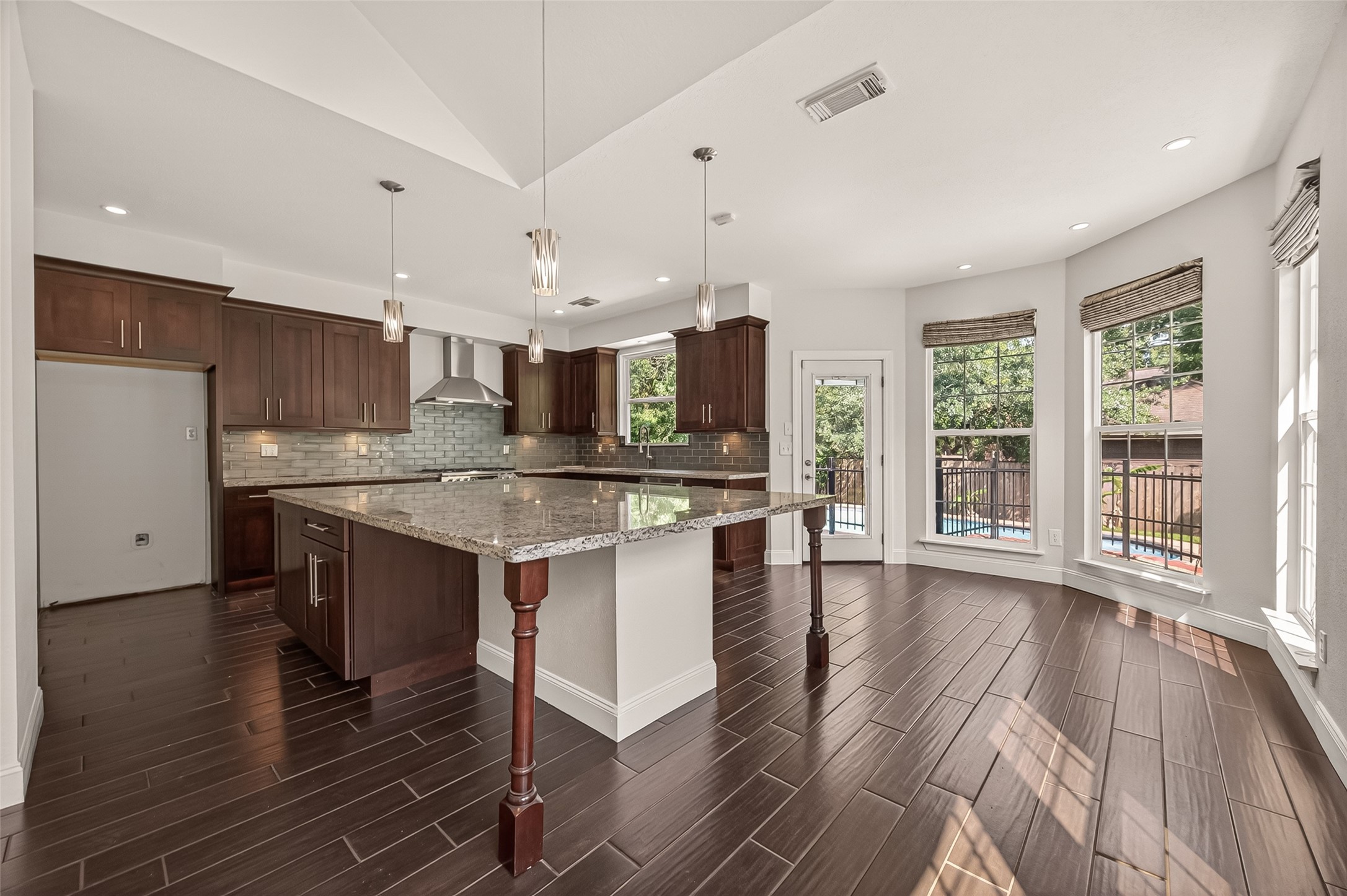 6131 Hampton Way Court Spring, TX 77389 - Photo 15 of 50 a kitchen with stainless steel appliances granite countertop a stove top oven a sink dishwasher a dining table and chairs with wooden floor