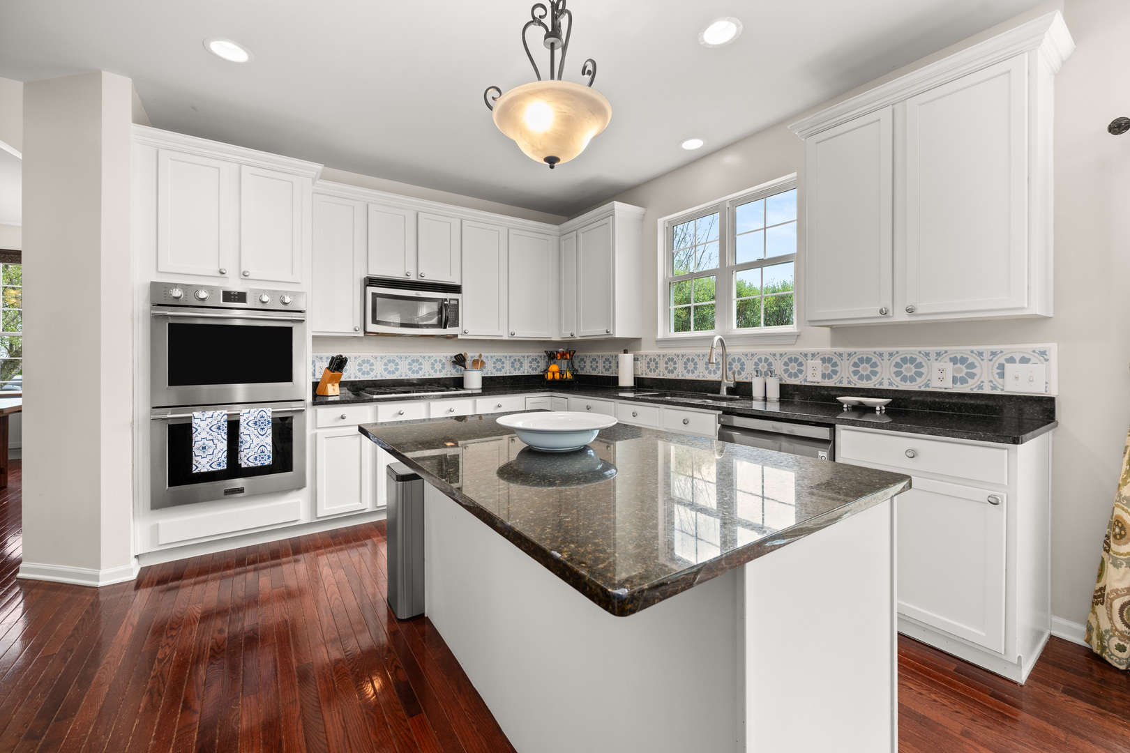 620 Northgate Drive Sycamore, IL 60178 - Photo 23 of 55 a kitchen with stainless steel appliances granite countertop a sink a stove and microwave