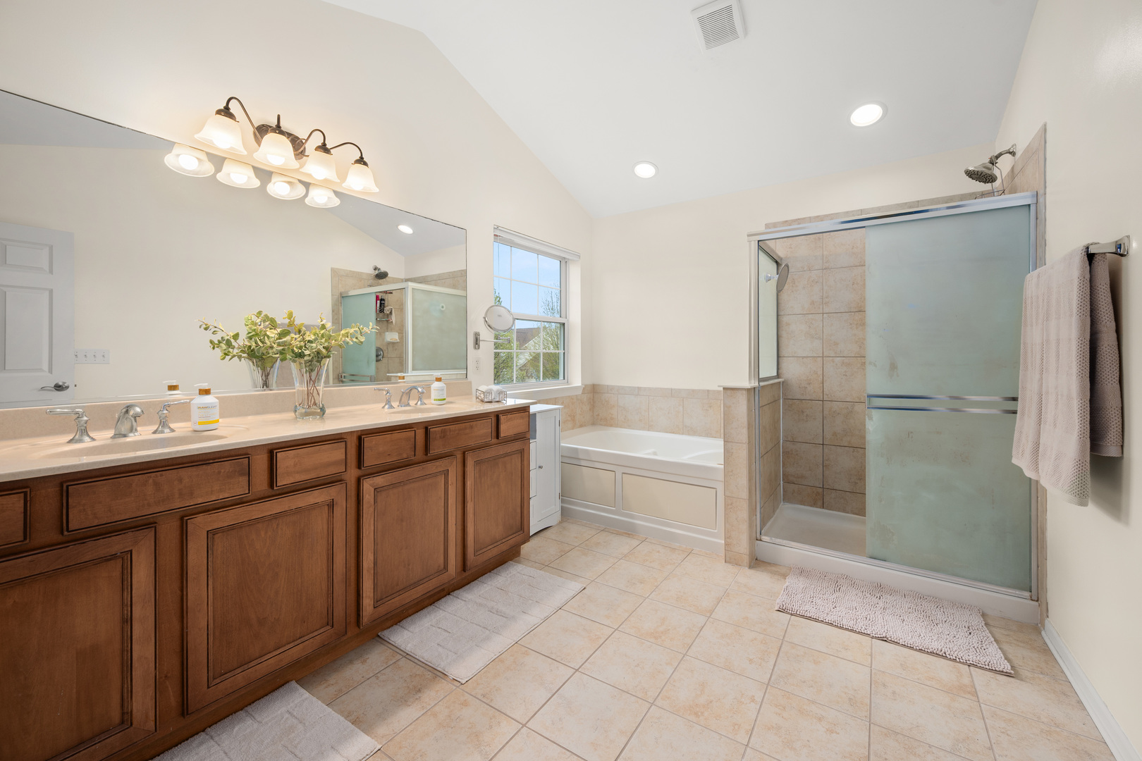 620 Northgate Drive Sycamore, IL 60178 - Photo 40 of 55 a bathroom with a granite countertop sink a large mirror and a bathtub