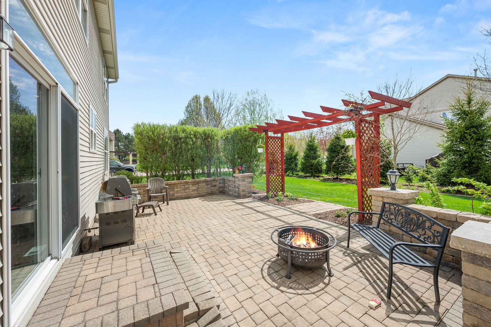 620 Northgate Drive Sycamore, IL 60178 - Photo 8 of 55 a view of a patio with table and chairs potted plants and palm tree