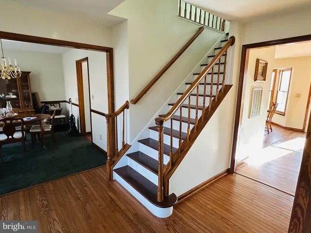 a view of entryway with wooden floor and stairs