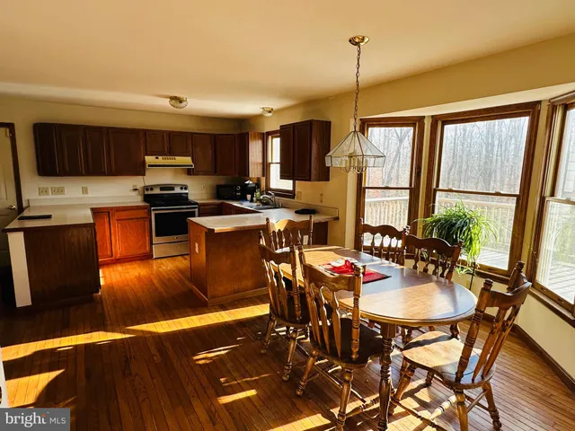 a view of a dining room with furniture window and wooden floor