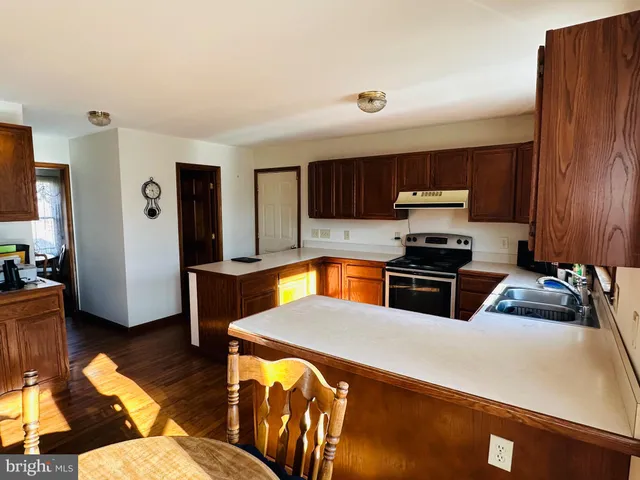 a kitchen with stainless steel appliances a stove a sink and a refrigerator
