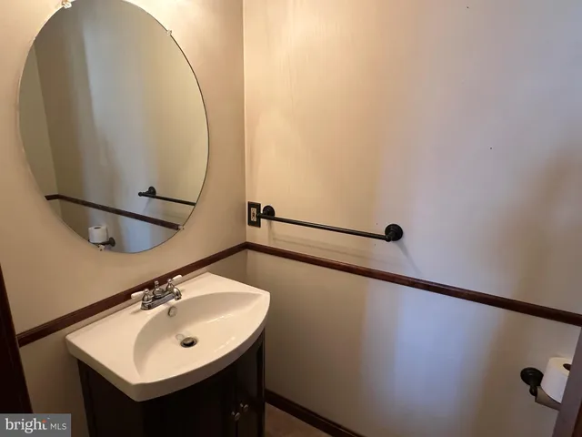 a bathroom with a sink and mirror