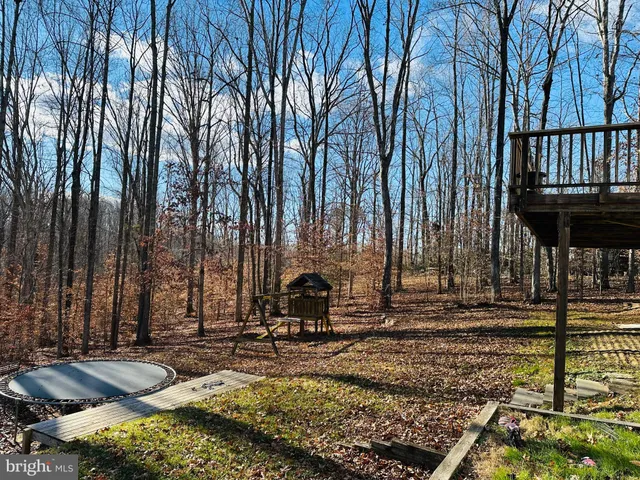 a backyard of a house with barbeque oven table and chairs
