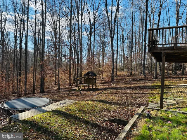 a backyard of a house with barbeque oven