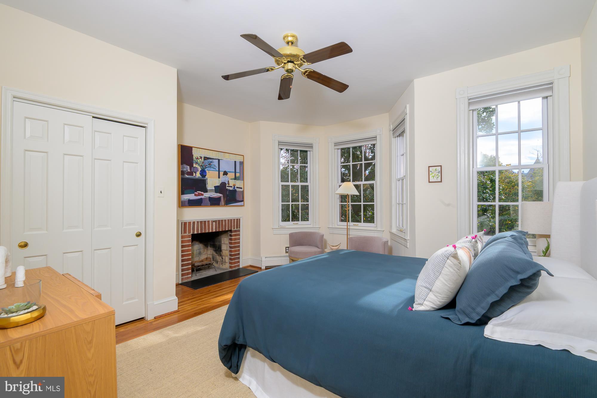 1330 Massachusetts Avenue Southeast Washington, DC 20003 - Photo 16 of 34 a bedroom with a bed dresser and a fireplace