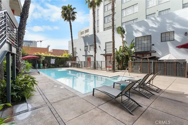 a swimming pool with outdoor seating and yard