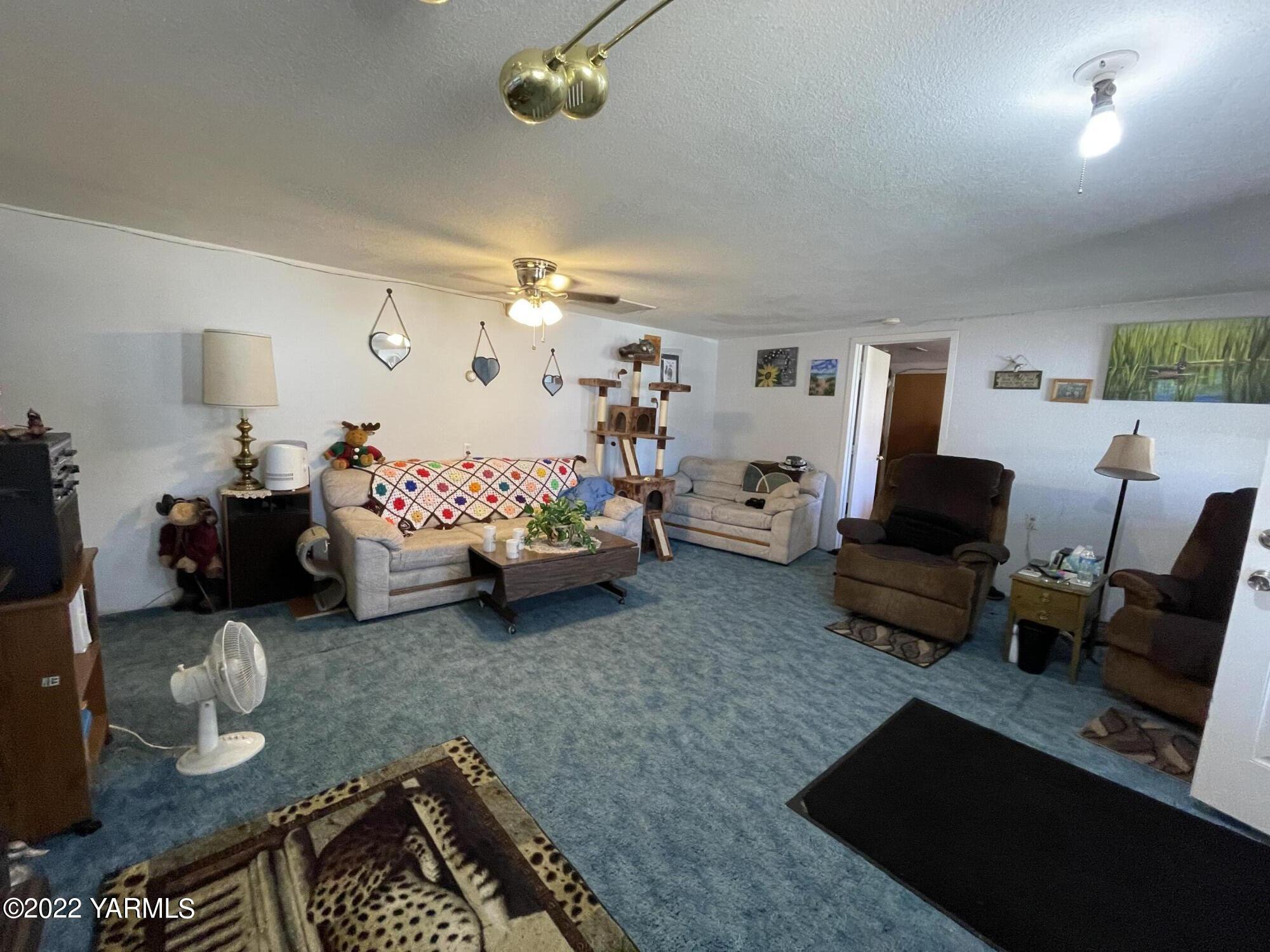 912 Beckner Road Sunnyside, WA 98944 - Photo 8 of 17 a bed room with furniture and a chandelier