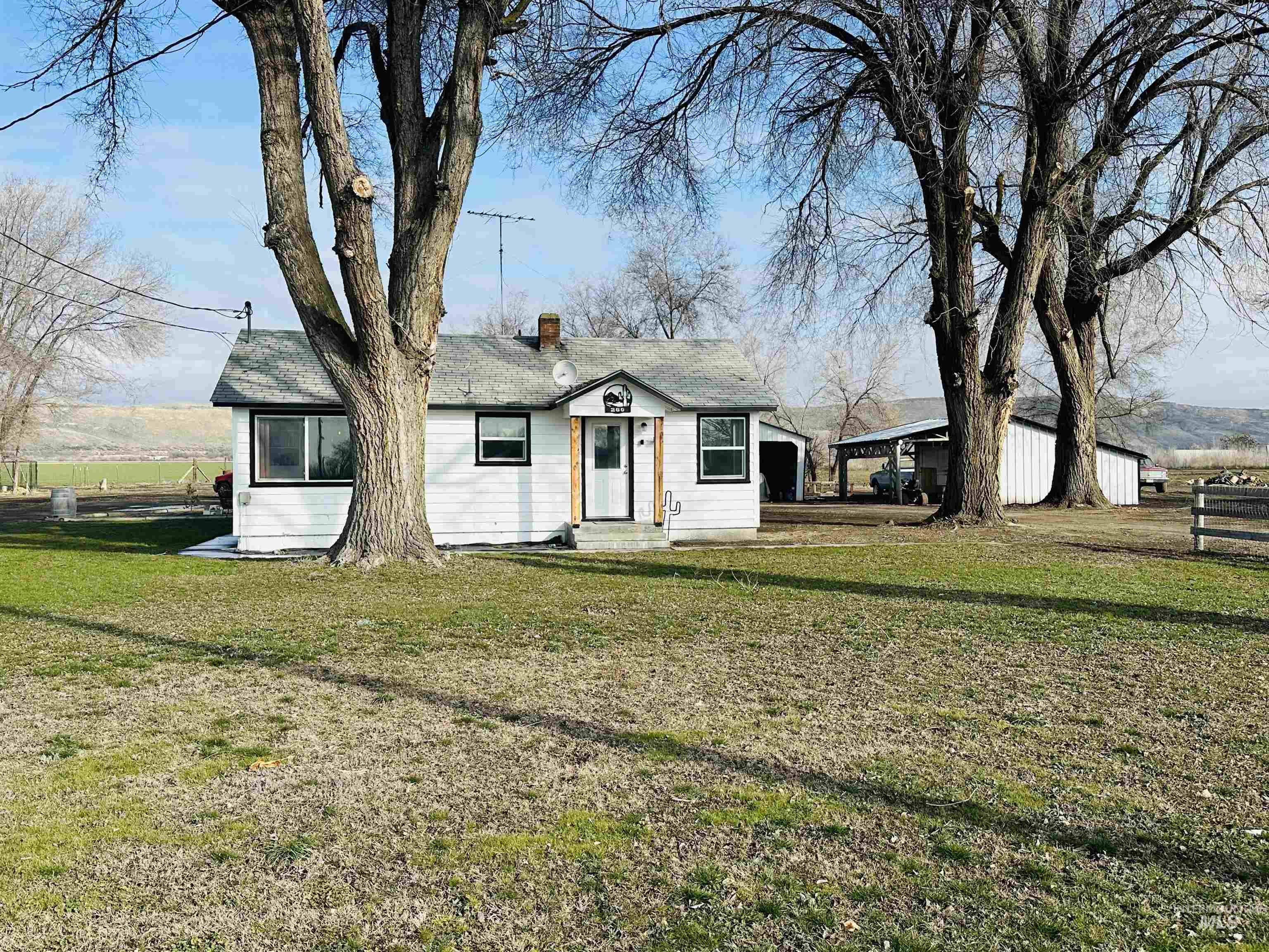 Bungalow with a chimney and a carport
