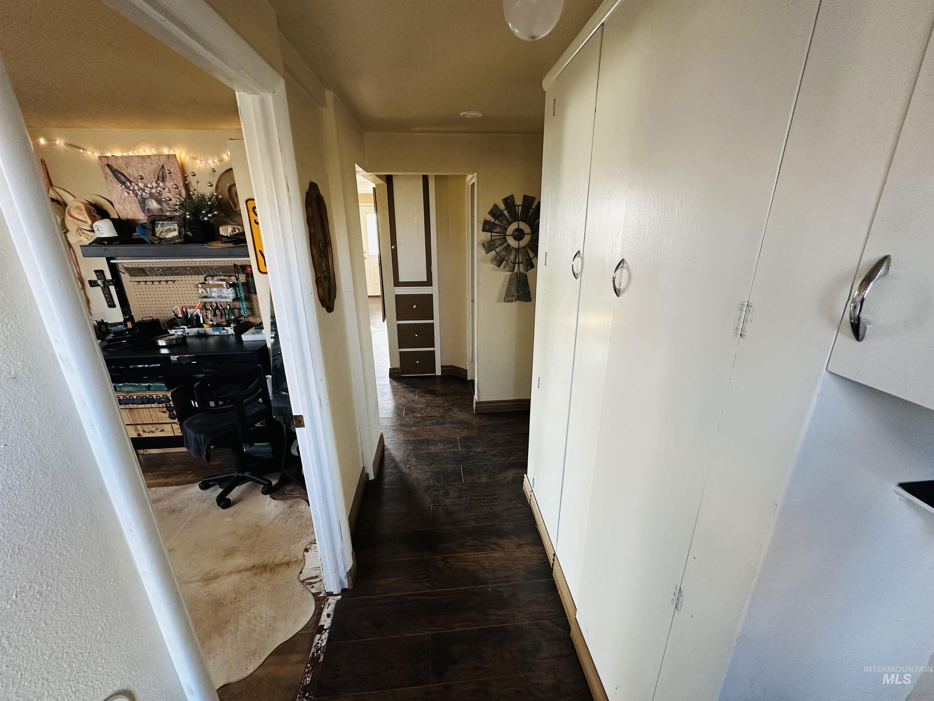 260 Highway 95 Weiser, ID 83672 - Photo 16 of 31 Hallway featuring dark wood-style floors and a desk