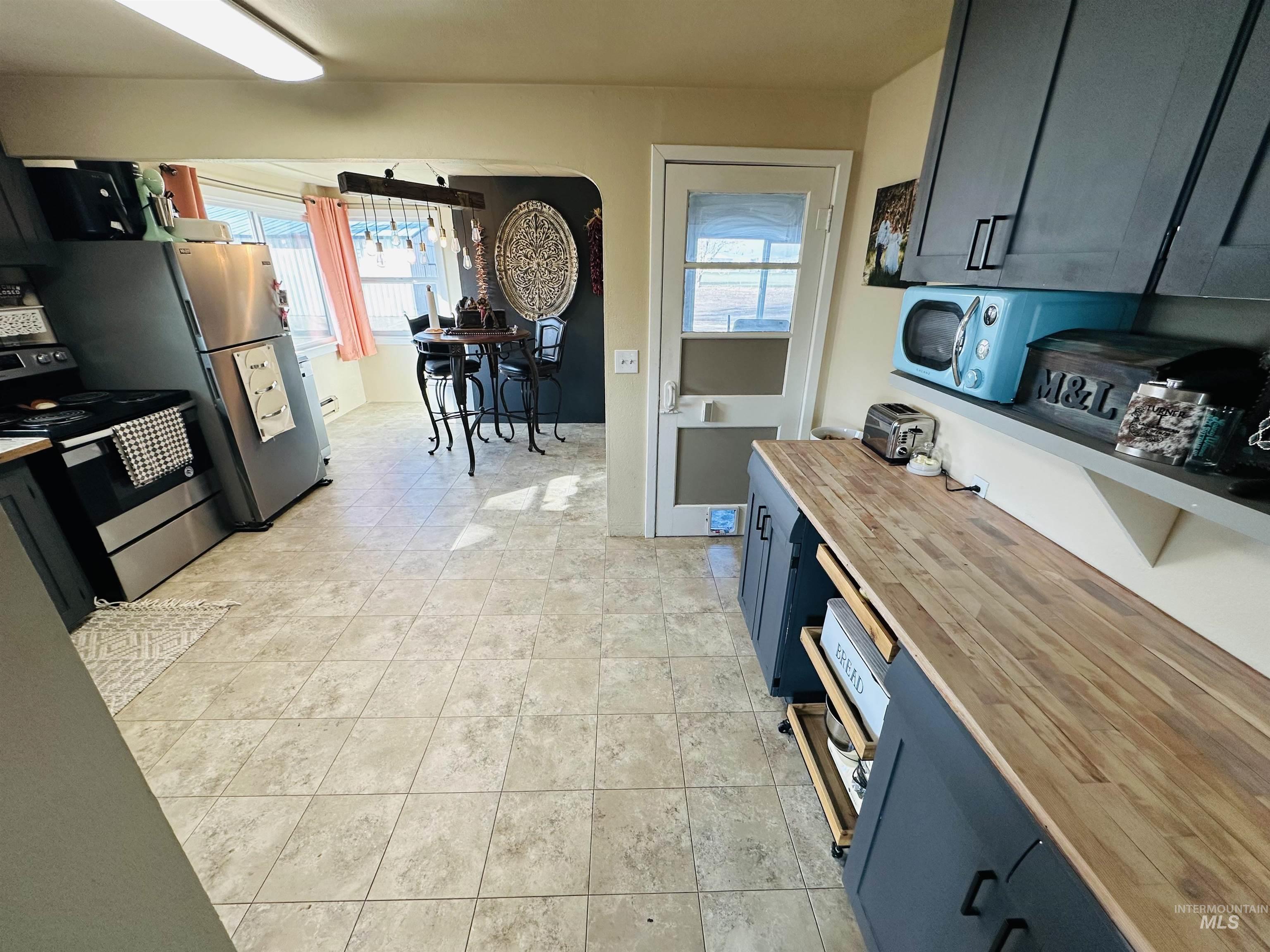 260 Highway 95 Weiser, ID 83672 - Photo 3 of 31 Kitchen with butcher block countertops, stainless steel electric range, and plenty of natural light