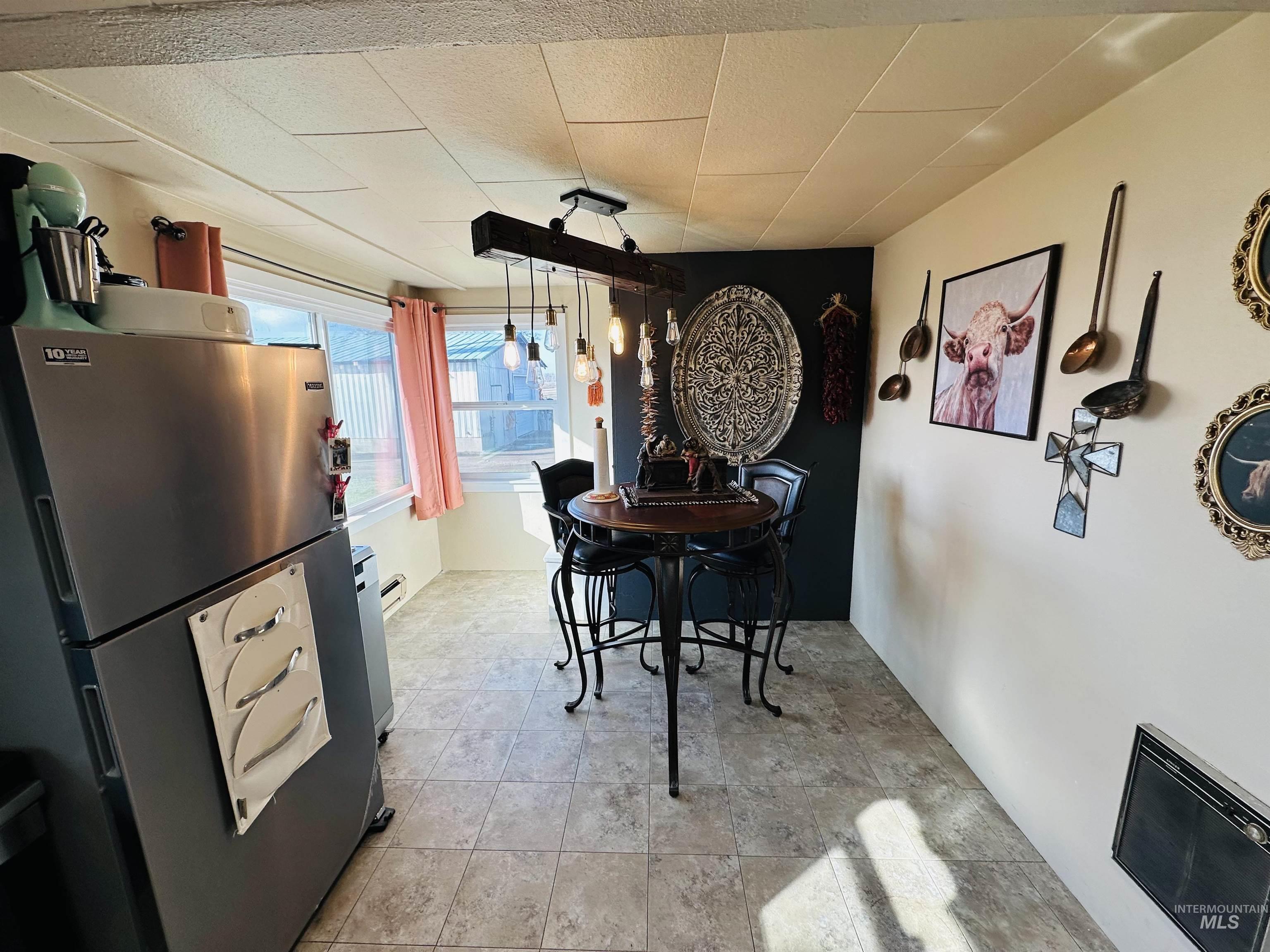 260 Highway 95 Weiser, ID 83672 - Photo 7 of 31 Dining space featuring stone finish flooring and a baseboard heating unit