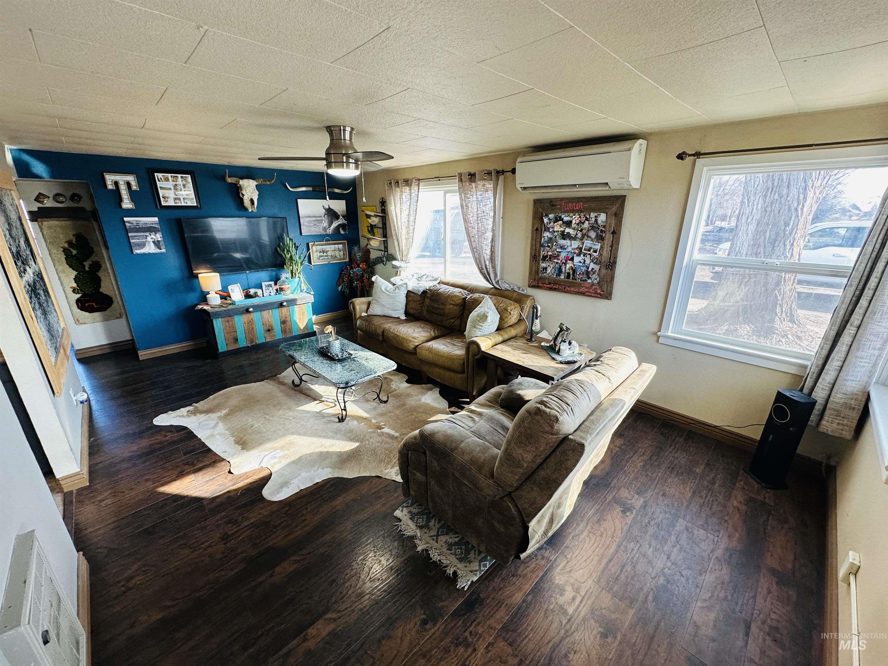 260 Highway 95 Weiser, ID 83672 - Photo 8 of 31 Living room featuring a ceiling fan, hardwood / wood-style floors, and a wall mounted air conditioner
