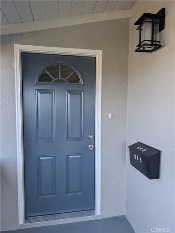 an empty room with closet and windows