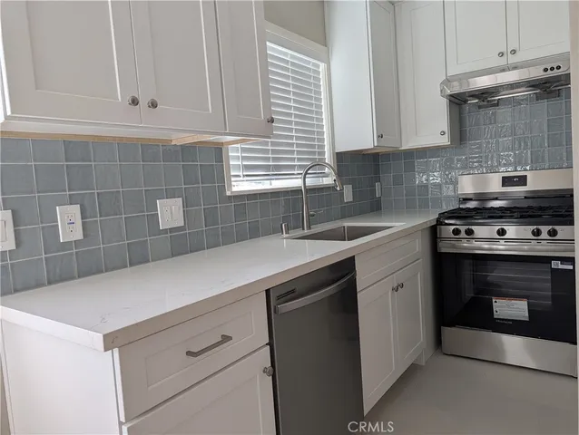 an empty room with a ceiling fan and window
