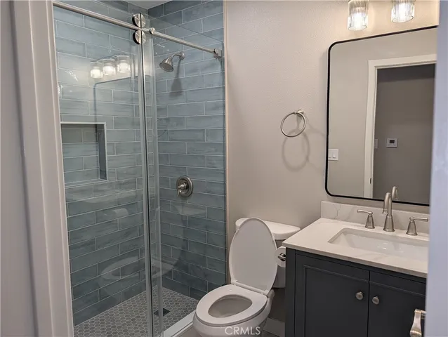 a bathroom with a double vanity sink mirror and toilet