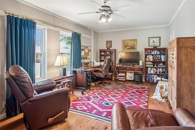 a living room with furniture a rug and a window