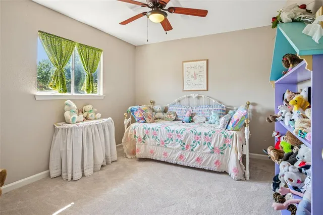 a bedroom with two beds and a window