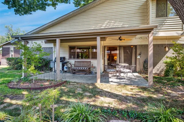 a view of a house with backyard porch and furniture