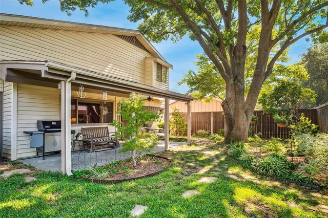 a front view of a house with a yard table and chairs