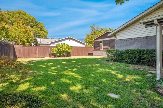 a view of a house with yard and a garden