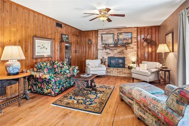 a living room with furniture fireplace and a large window