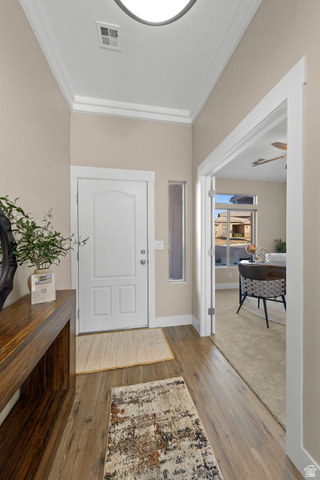 1570 South Rio Virgin Drive Washington, UT 84780 - Photo 7 of 71 Entryway featuring light wood-style flooring, crown molding, and light carpet