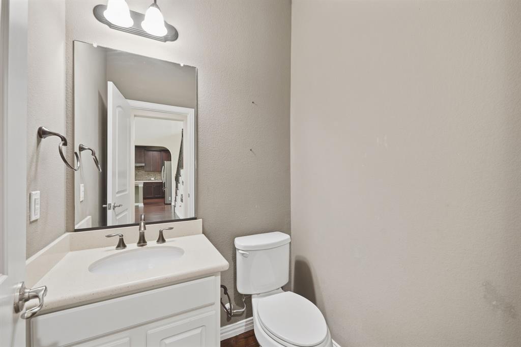 12809 Spring Hill Drive Frisco, TX 75035 - Photo 23 of 37 a bathroom with a toilet sink and mirror