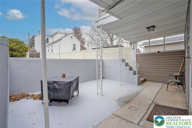 a view of a house with a yard and sitting area