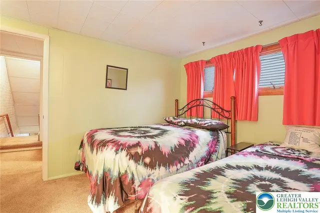 a view of a bedroom with clothes and shoes